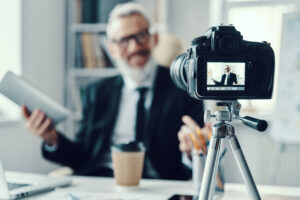 Real estate agent collecting a short video testimonial from happy clients on closing day